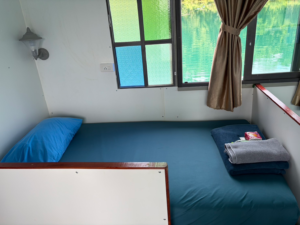 Signature AC house bed beside a lake-view window