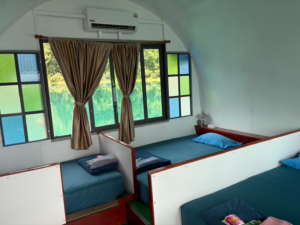 Signature AC house interior with one queen bed and two single beds