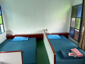 Two single beds inside the Signature AC house